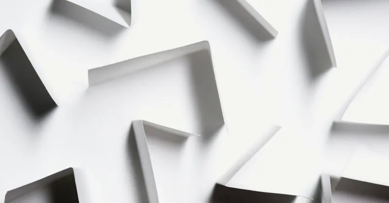 Abstract white paper shapes creating a modern geometric design with shadows.