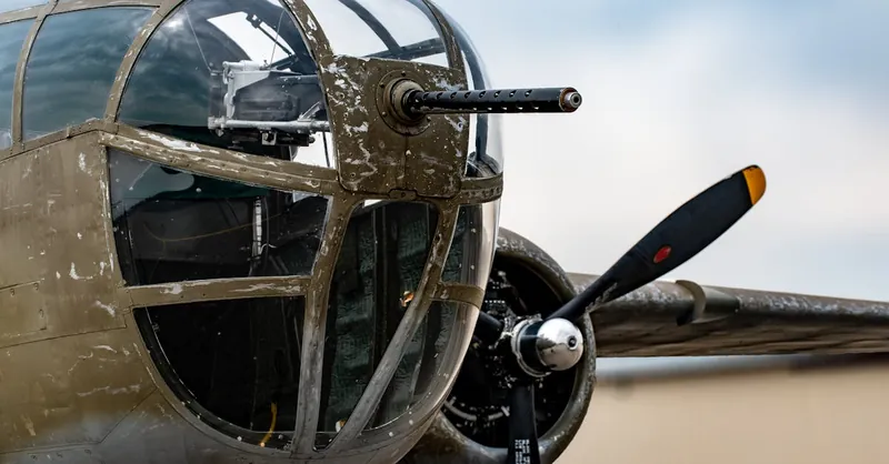 Detailed view of a vintage military aircraft nose and propeller. World War II era.