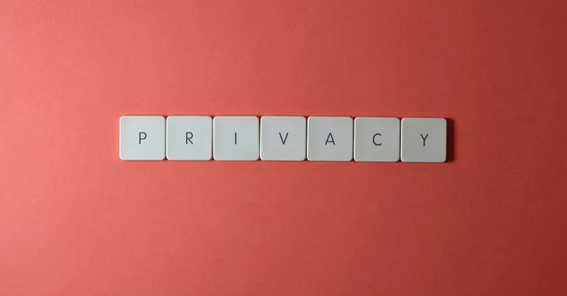 Close-up of letter tiles spelling PRIVACY on a red background, symbolizing data protection.