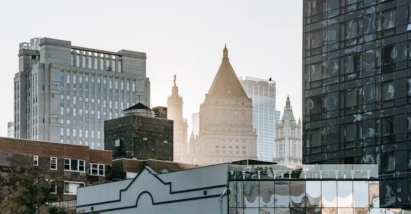 A blend of modern and historic architecture in a city skyline at daylight.
