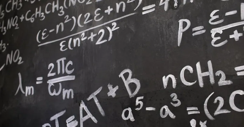 Close-up view of a blackboard filled with complex mathematical equations and formulas.