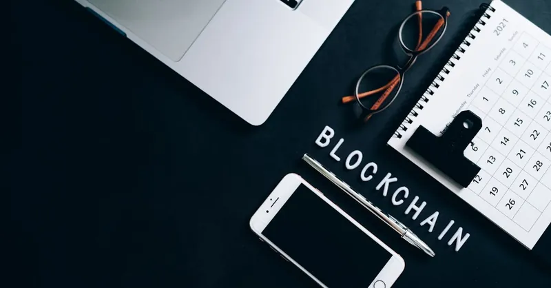 Top view of a modern digital workspace with blockchain theme essentials.